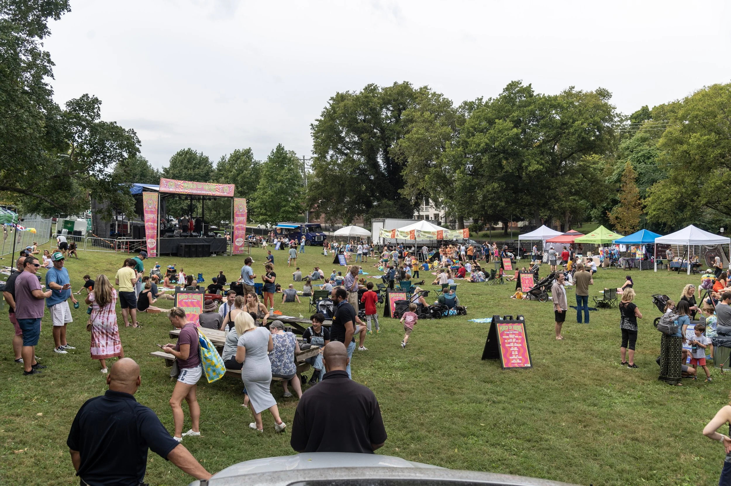 Festival goers and a schnauzer on the lawn at Touch of Brews 2021