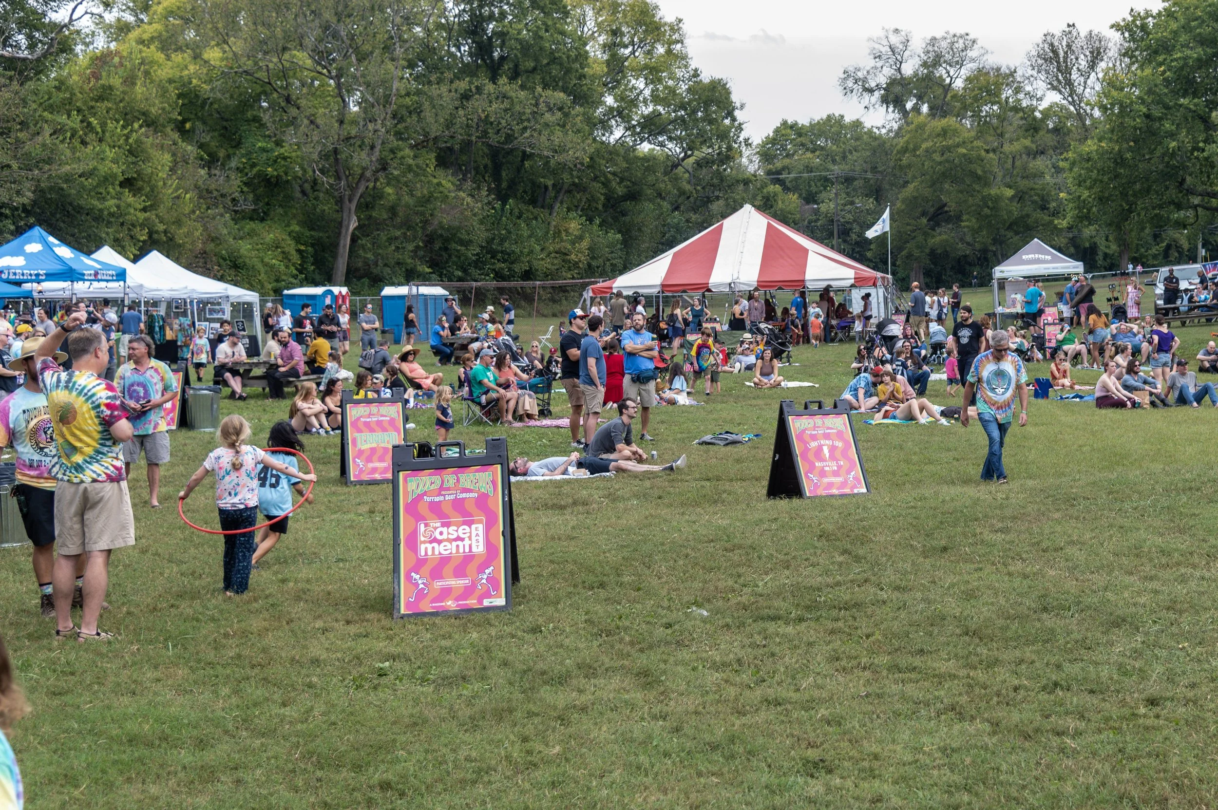 A kid with a hula hoop on the lawn at Touch of Brews 2021