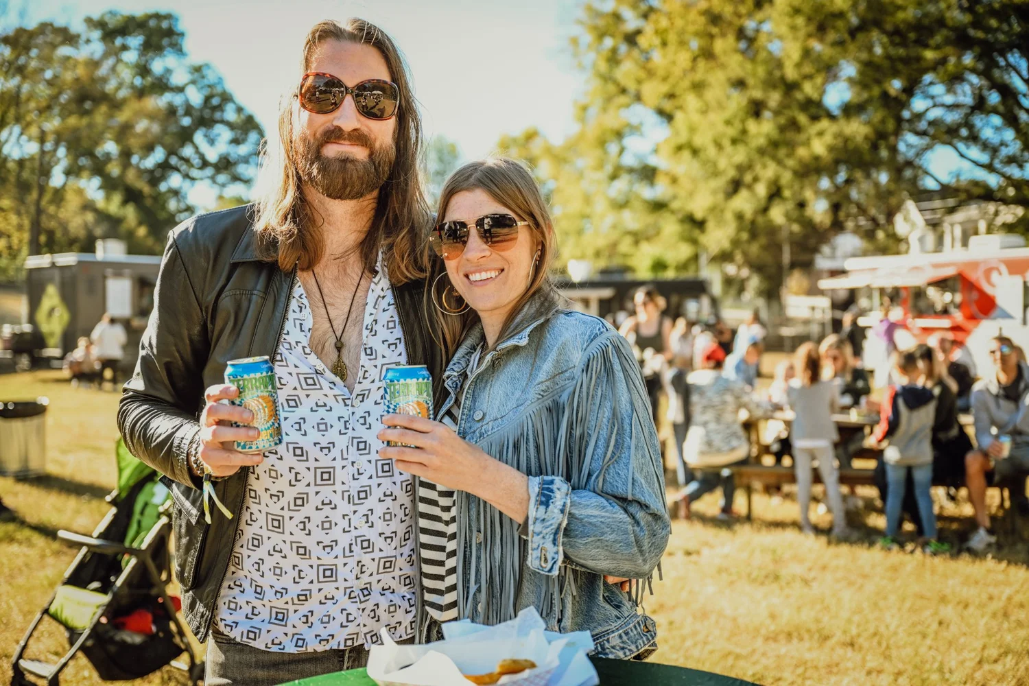 A couple with Terrapin cans by the food trucks at Touch of Brews 2022
