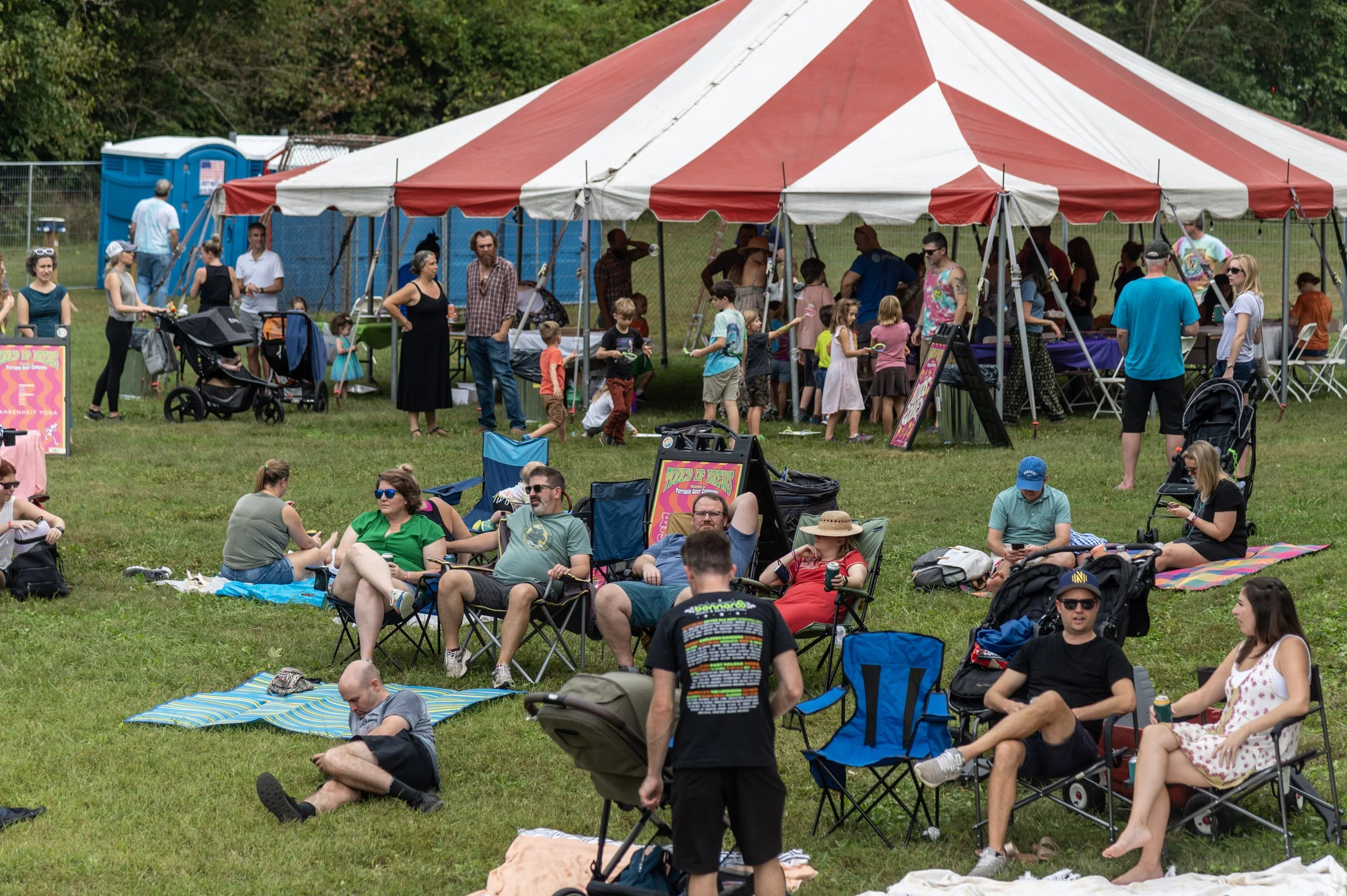 Families under the Kids Zone tent at the first Touch of Brews