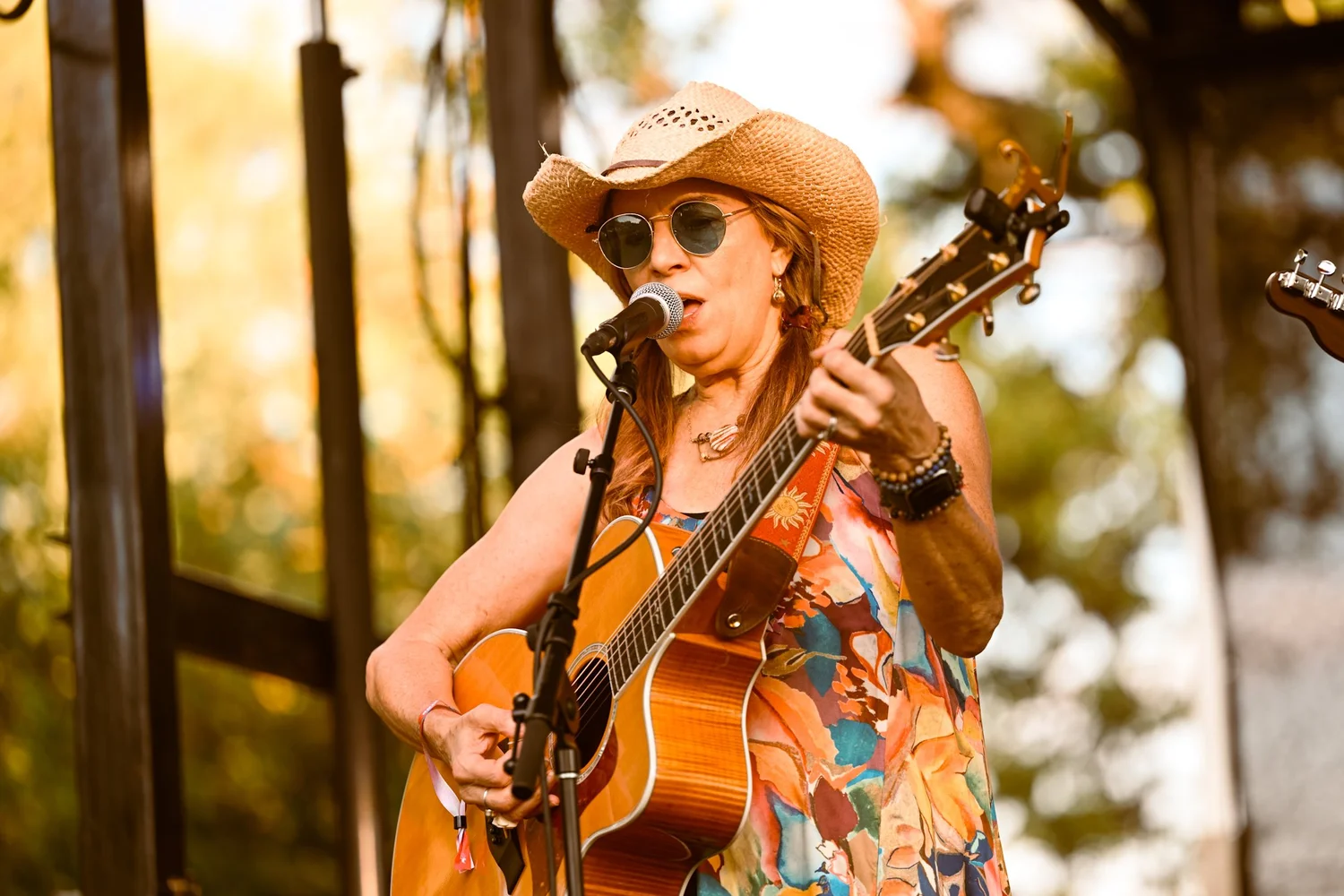 A singer in a straw hat performing at Touch of Brews 2023 in Nashville