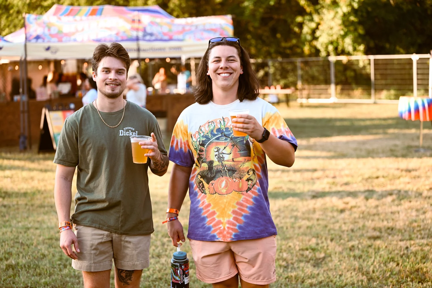 Two friends with cold beers and Grateful Dead tie dye at Touch of Brews 2023