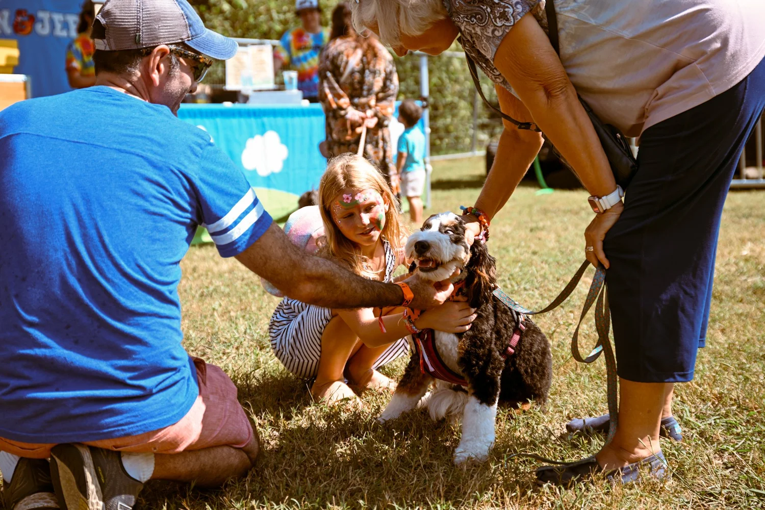 A leashed dog greeting festival goers at Touch of Brews in Nashville